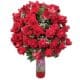 100 red roses in a vase with green plants
