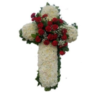 Sympathy white cross with red flowers on the center arrangement