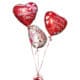 Red and white hearth shaped balloons with the word Happy Valentines Day
