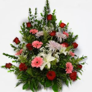 Bouquet in a basket with 12 Roses, 7 Gerberas Daisies, 3 Spiders, 2 while Lilies.