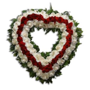 Sympathy heart shape floral arrangement with red and white roses
