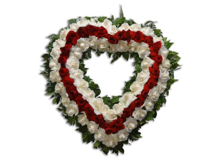 Sympathy heart shape floral arrangement with red and white roses