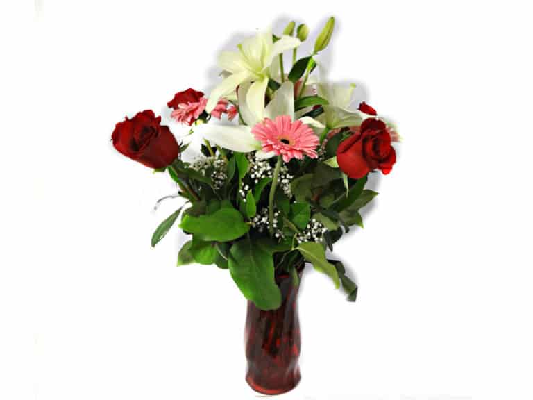 Flower in a vessel with 7 Roses, 6 Gerberas, 2 Lilies.