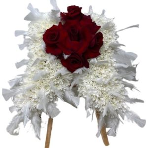 Funeral Arrangement small white flowers wings with red roses on the center