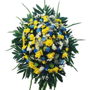 Funeral Arrangement with yellow , blue and white flowers with green
