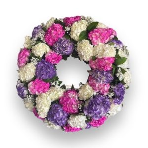 Funeral Arrangement round with pink, purple and purple flowers